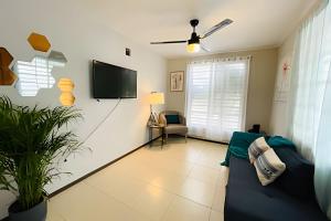 a living room with a couch and a flat screen tv at Exclusive Place 10PX 8 Beds Wi-Fi Parking in Reynosa