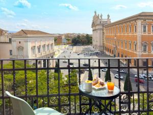 a table with a plate of food on a balcony at Casa Cecilia in Rome