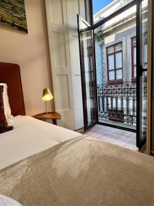 a bedroom with a bed and a large window at Douro Views by MyMoradia in Porto