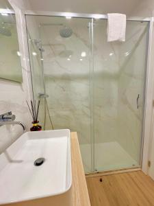 a bathroom with a shower and a white sink at Douro Views by MyMoradia in Porto +7 photos