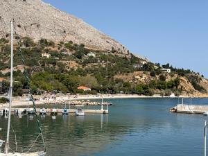 a marina with boats in the water next to a hill at THALASSA Seafront in Vrontados