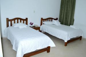 two beds sitting next to each other in a room at Azul House in Punta Arenas