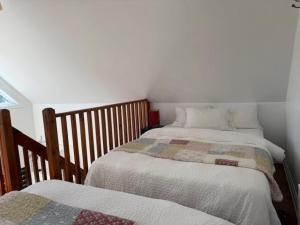 a bedroom with two twin beds and a window at Le Chalet d'Isabelle in La Conception