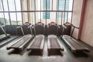 a row of treadmills in a gym with windows at Secrt Sabana 2BR · Workspace + WiFi · Parking · Pool & Gym · Apt 1213 in San José +78 photos