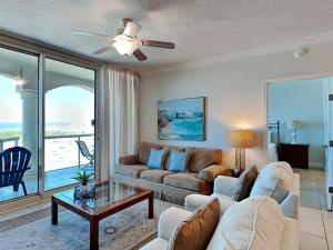 a living room with a couch and a table at Portofino Island Resort #2-1002 in Pensacola Beach