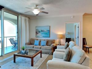 a living room with two couches and a table at Portofino Island Resort #2-1002 in Pensacola Beach