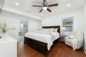 1 dormitorio con 1 cama, ventilador de techo y silla en Southern charm, en Charleston