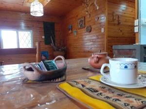 a wooden room with a table with a cup on it at Pacha Quilla in El Mollar
