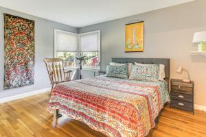 a bedroom with a bed and a chair at 1 Mi to Capron Park Zoo Quiet Family Getaway in Attleboro