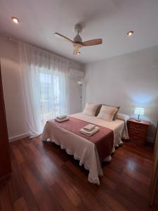 a bedroom with a bed and a ceiling fan at Nueva Córdoba Judería in Córdoba +37 photos