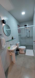 a bathroom with a sink and a toilet and a shower at Espaço Harmonia - um apartamento inteiro e aconchegante para vc! in Curitiba +14 photos