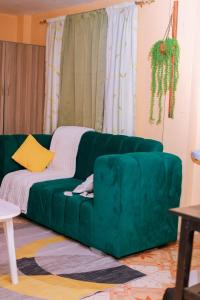 a green couch sitting in a living room at Monett Bay in Wajir