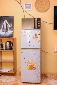 a refrigerator with a microwave on top of it at Monett Bay in Wajir