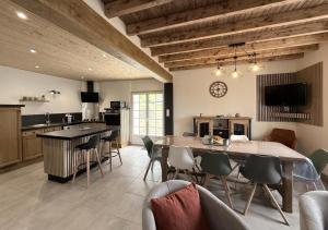 a kitchen and dining room with a table and chairs at Gliget in Lourdios-Ichère
