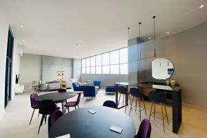 a dining room with tables and chairs and a table at Beautiful apartment, BBQ, A.C, 5 min Arena, Gym in Contla