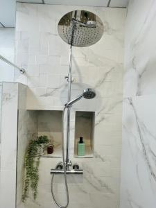 a shower with a shower head in a bathroom at New studio next to Ruzafa in Alcácer