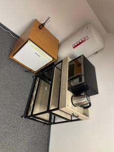 an overhead view of a kitchen with a microwave and a tv at B&M Studio self-check in in Vilnius