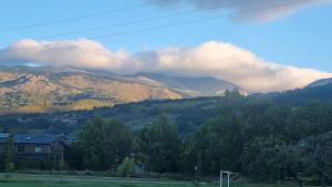 a view of a mountain range with clouds in the sky at Llivia 1876 in Llivia