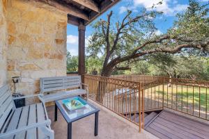 a porch with a bench and a table at 5 Mi to Lake Travis Pet-Friendly Home with Yard! in Buffalo Gap
