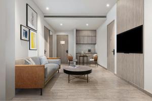 a living room with a couch and a table at Four Points by Sheraton Jakarta Thamrin in Jakarta