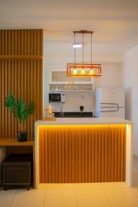a kitchen with a large yellow counter with a stove at COP30 - Apê Amazônia Living - Sem reserva mínima - 4 Camas - Umarizal - Belém in Belém