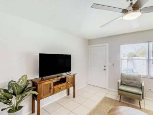 a living room with a flat screen tv and a chair at Family & Pet Friendly-Waterfront-Sleeps 4 in Apollo Beach +14 photos