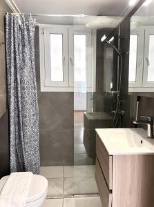 a bathroom with a shower and a toilet and a sink at Hellenic Pleasure Residences in Athens +16 photos