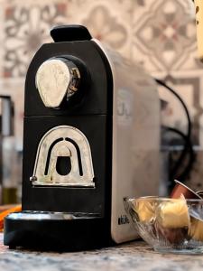 a toaster sitting on a table next to a bowl of food at Modern and quiet apartment in Beni Mellal