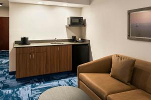 a room with a couch and a sink and a microwave at Fairfield Inn & Suites by Marriott Somerset in Somerset