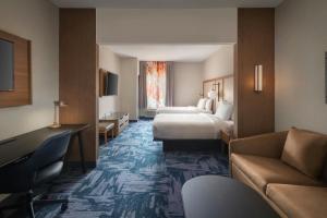 a hotel room with two beds and a couch at Fairfield Inn & Suites by Marriott Somerset in Somerset +9 photos