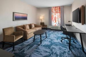 a living room with a couch and a piano at Fairfield Inn & Suites by Marriott Somerset in Somerset