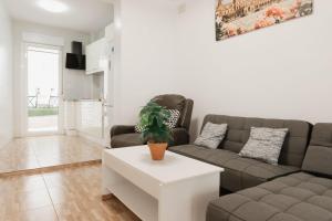 a living room with a couch and a table at Casa de dos plantas ,Las niñas in La Algaba