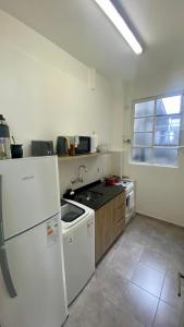 a kitchen with a white refrigerator and a stove at Alojamiento en San Telmo in Buenos Aires