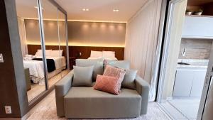a living room with a couch and a bedroom at #2905# Flat incrível– Lounge 22 | Setor Oeste in Goiânia +37 photos