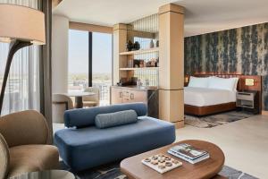 a hotel room with a bed and a couch at The REMI Scottsdale, Autograph Collection in Scottsdale +80 photos