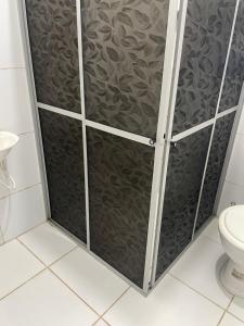 a shower stall in a bathroom with a toilet at Condomínio Dom Francisco in Belém