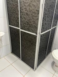 a shower with a glass door in a bathroom at Condomínio Dom Francisco in Belém