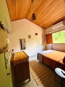 a bedroom with two beds and a wooden ceiling at Loft Dreamtime - a 80 metros do Rio das Almas! in Pirenópolis +43 photos