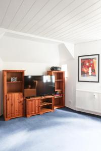 a living room with a large flat screen tv at Ferienapartments in Schierke am Brocken direkte Wanderweglage in Wernigerode