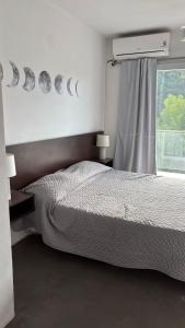 a bedroom with a bed and a window at Latitud 28 in Mar Azul