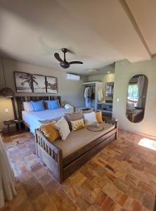 a large bedroom with a bed and a couch at Casa de Hóspedes da Lili & André in Caraíva