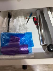 a drawer filled with plastic bags and utensils at Apartament Brazdă in Craiova +20 photos