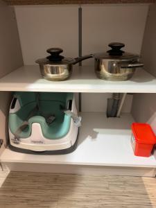 a kitchen appliance sitting on top of a shelf at Apartament Brazdă in Craiova