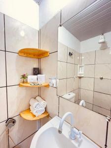 a bathroom with a sink and a mirror at Casa Baly Jericoacoara in Jericoacoara +27 photos