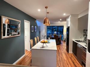 a kitchen and dining room with a table and chairs at 2 Bedroom Townhouse - Close to Beach in Torquay