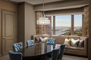 a dining room with a couch and a table and chairs at Fairmont Chicago Millennium Park in Chicago