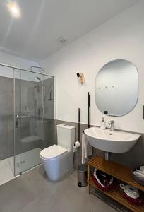a bathroom with a toilet and a sink and a shower at Los Castaños in La Alberca +23 photos