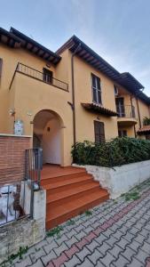 a house with a staircase in front of it at Relax e vista Lago Trasimeno vicino Montepulciano in Sant'Albino