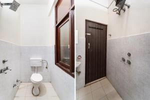 a bathroom with a toilet and a sink and a mirror at Hotel O Landlord in Rohtak