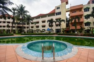 a swimming pool in front of a building at Hotel O Ritz Rivera in Kolkata